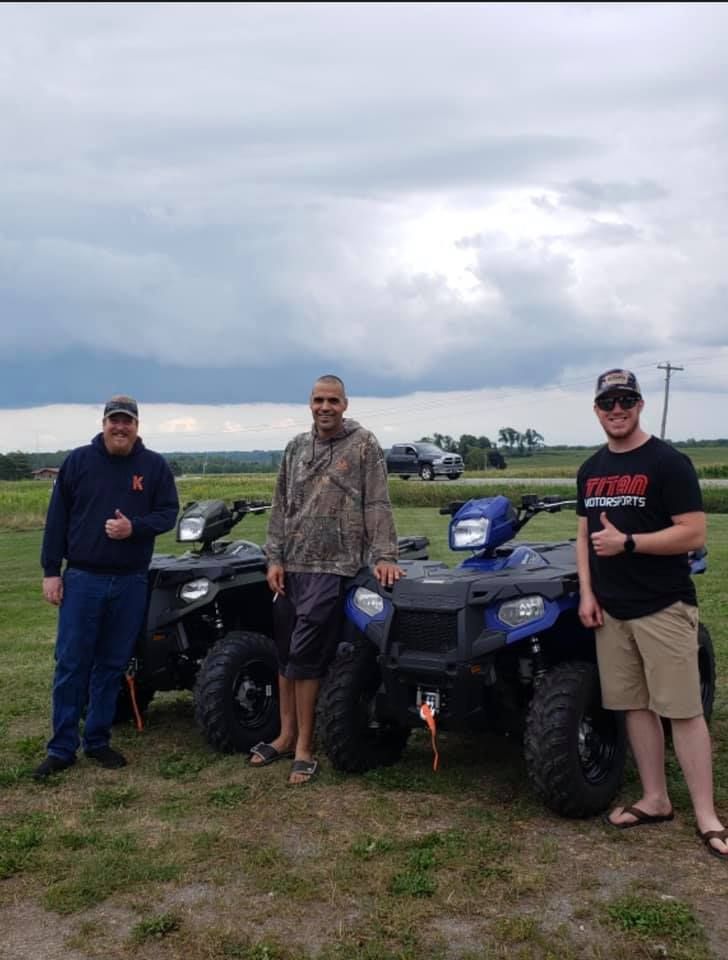 Customer with their new Polaris ATVs